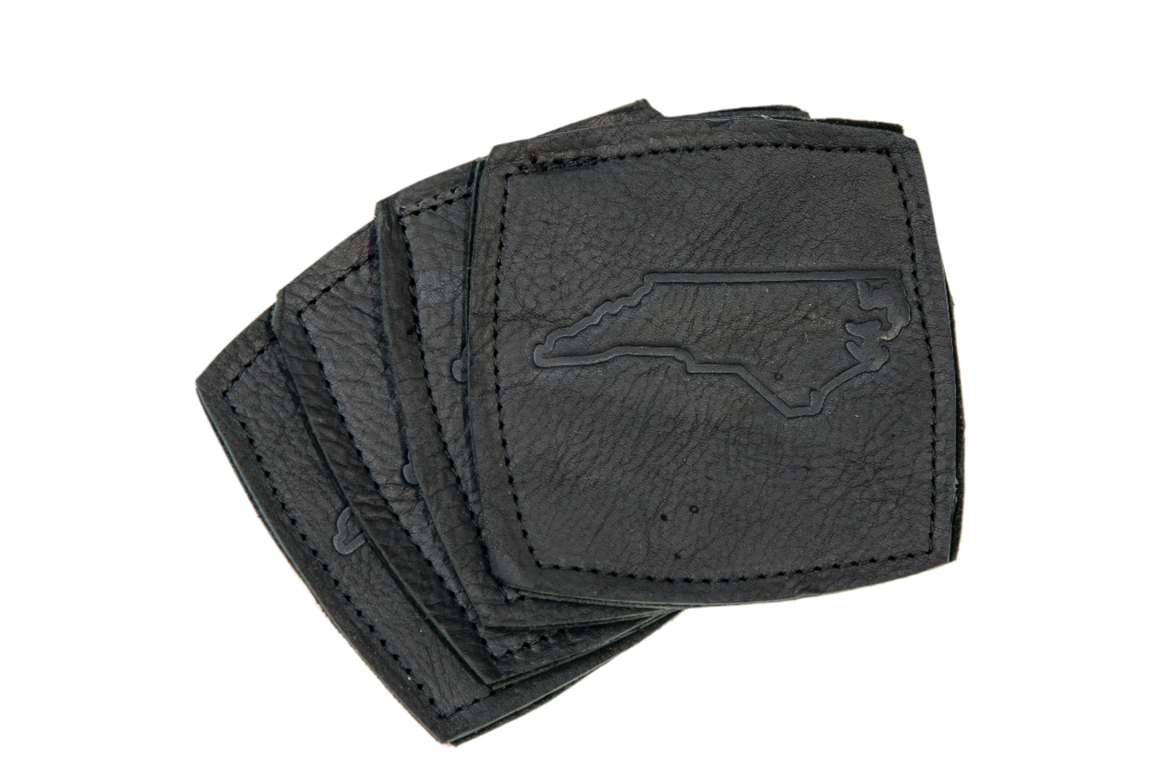 Leather coaster set of 4 in black leather with NC state imprint.